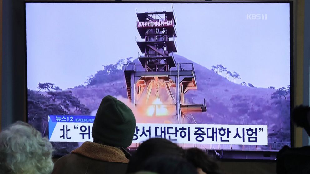 People watch a TV screen showing a file image of a ground test of North Korea's rocket engine during a news program at the Seoul Railway Station in Seoul, South Korea, Monday, Dec. 9, 2019. North Korea said Sunday it carried out a "very important tes
