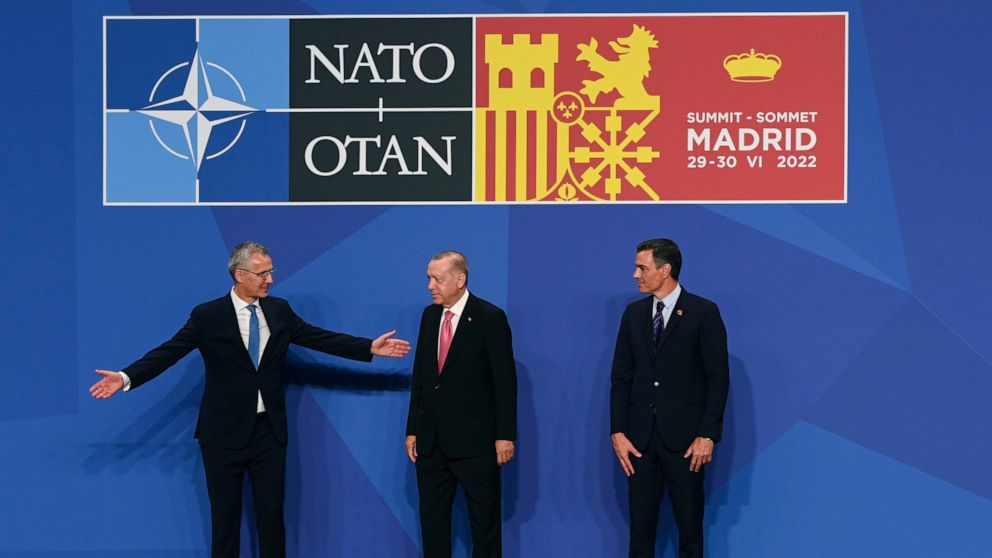 Turkish Prime Minister Recep Tayyip Erdogan is greeted by NATO Secretary General Jens Stoltenberg, left and Prime Minister Pedro Sanchez of Spain, during the NATO summit in Madrid, Spain, Wednesday, June 29, 2022. NATO leaders are meeting in Madrid a