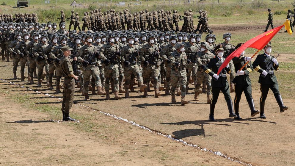 FILE - In this photo released by the Russian Defense Ministry Press Service, Chinese troops line up (march) during the Vostok 2022 military exercise at a firing range in Russia's Far East, on Aug. 31, 2022. A Japanese government-commissioned panel sa