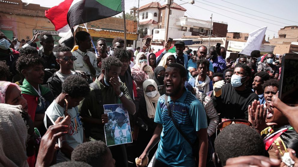 People chant slogans during a protest in Khartoum, Sudan, Monday, Jan. 17, 2022. Thousands of people took to the streets on Monday to protest the Oct. 25, 2021 coup that has plunged the country into grinding deadlock. (AP Photo/Marwan Ali)