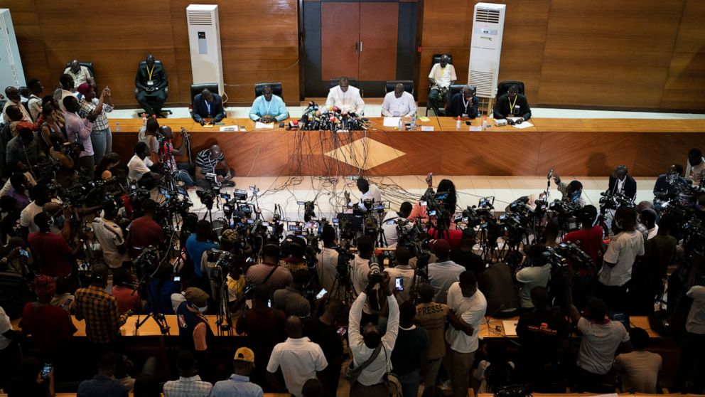 The president of the National Commission for the Census of Votes, Siré Aly Ba, center, speaks to journalists in Dakar, Senegal, Thursday, Aug. 4, 2022. The country's ruling coalition party has lost an absolute majority in the national assembly, accor