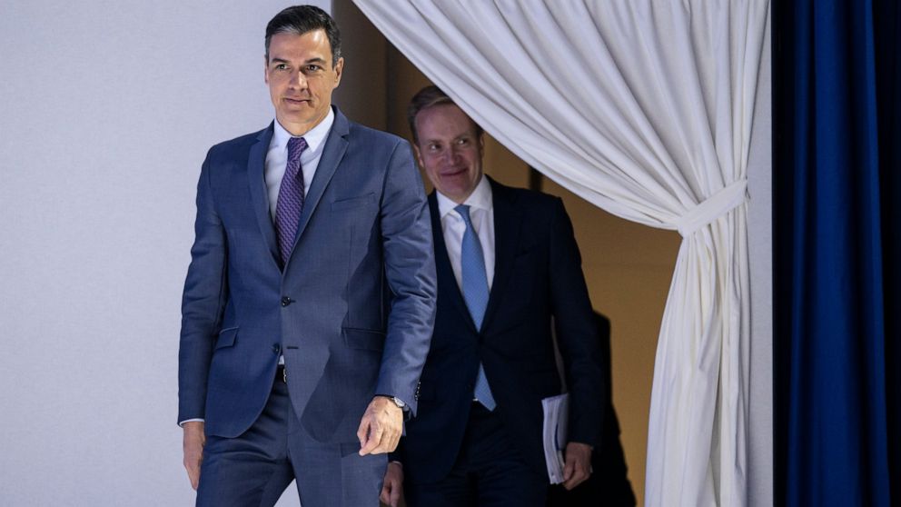 Pedro Sanchez, Prime Minister of Spain, left, arrives ahead of Borge Brende, President, World Economic Forum at the 51st annual meeting of the World Economic Forum, WEF, in Davos, Switzerland, Tuesday, May 24, 2022. The forum has been postponed due t