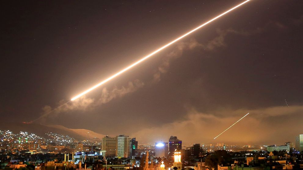FILE - In this early Saturday, April 14, 2018 file photo, Damascus skies erupt with surface to air missile fire as the U.S. launches an attack on Syria targeting different parts of the Syrian capital Damascus, Syria. A spokesman for the U.S.-led coal