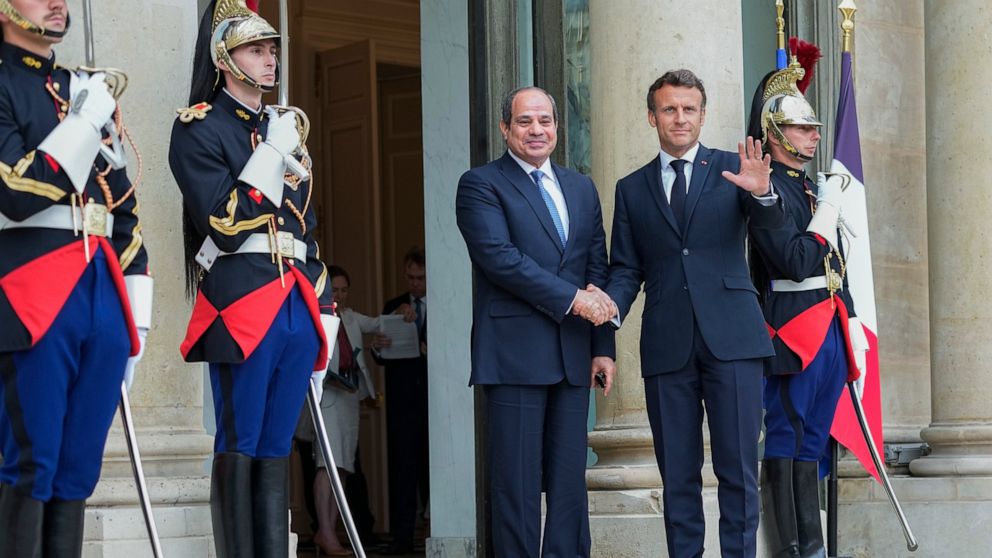 Egyptian President Abdel Fattah el-Sissi, left, is welcomed by French President Emmanuel Macron at the Elysee Palace, Friday, July 22, 2022. (AP Photo/Michel Euler)
