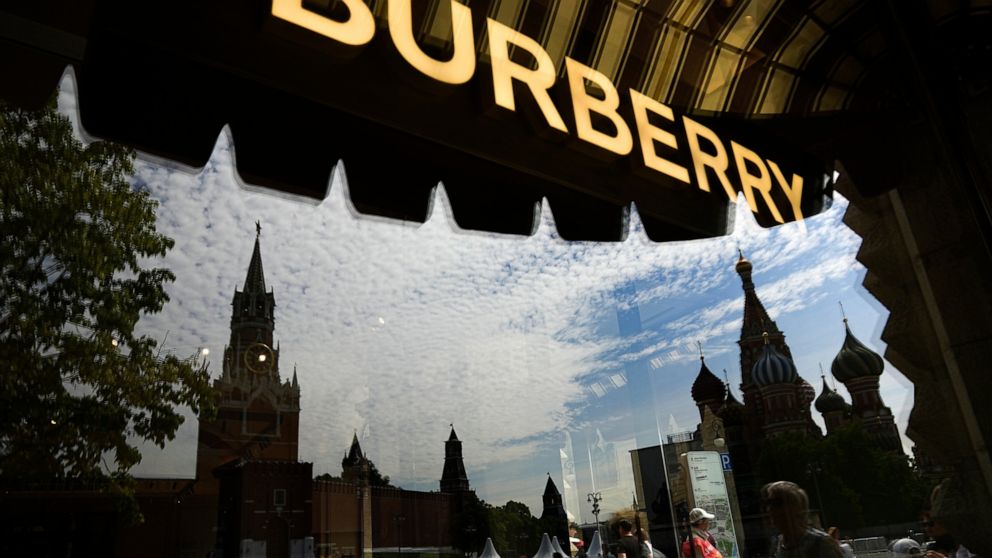 St. Basil's Cathedral and the Spasskaya Tower are reflected in a window of an almost empty and dark Burberry boutique, closed due to sanctions, inside the GUM department store in Moscow, Russia, Wednesday, June 1, 2022. As Russia's military operation