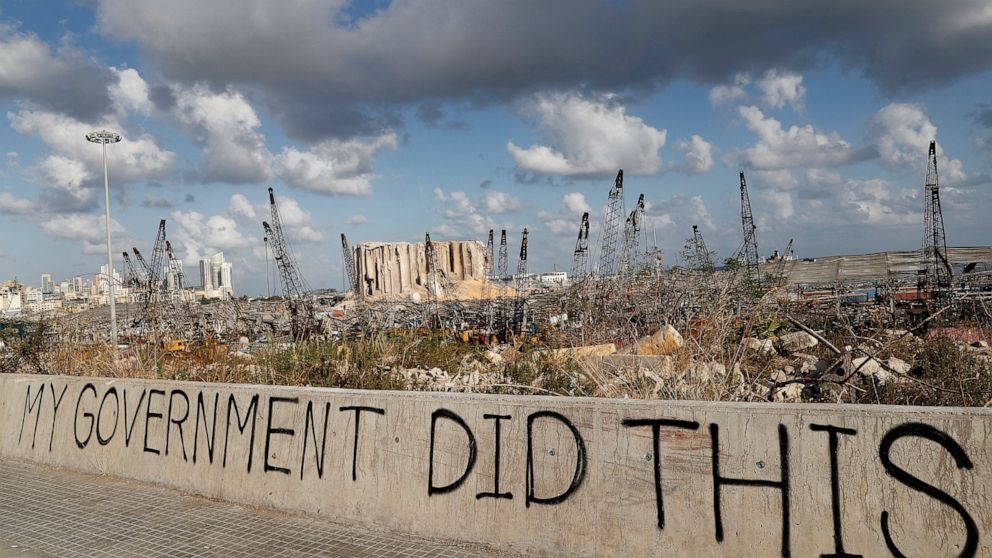 Words are written by Lebanese citizens in front of the scene of Tuesday's explosion that hit the seaport of Beirut, Lebanon, Sunday, Aug. 9, 2020. Public fury over the massive explosion in Beirut took a new turn Saturday night as protesters stormed g