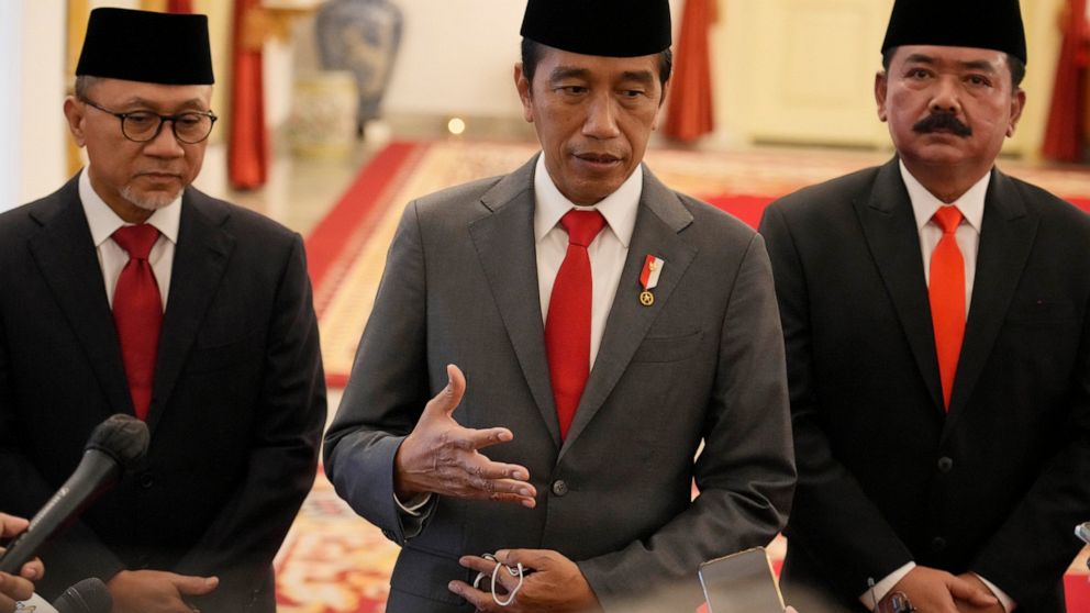 Indonesian President Joko Widodo , center, gestures during a joint press conference with Trade Minister Zulkifli Hasan, left, and Agrarian and Spatial Planning Minister Hadi Tjahjanto, right, after an inauguration ceremony at Merdeka Palace in Jakart