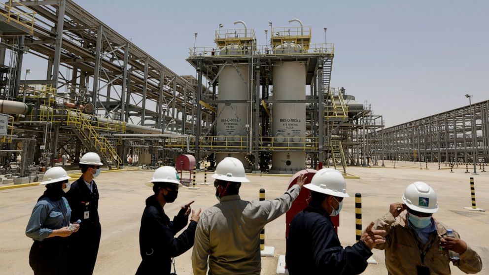 FILE - Saudi Aramco engineers and journalists look at the Hawiyah Natural Gas Liquids Recovery Plant in Hawiyah, in the Eastern Province of Saudi Arabia on June 28, 2021. Saudi oil company Aramco’s half-year profits peaked just shy of $88 billion for