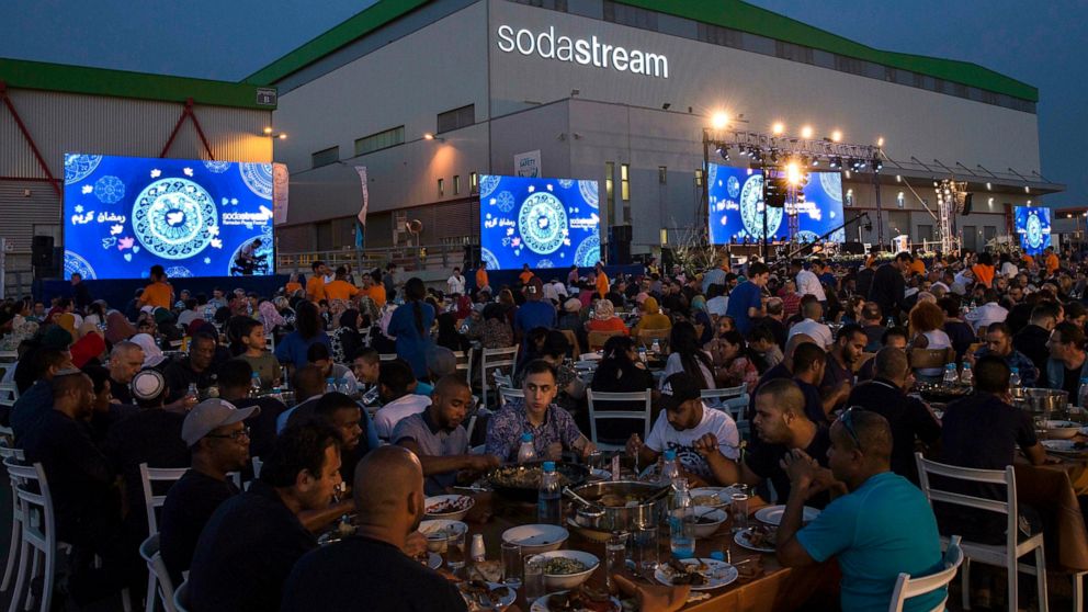 Bedouins, Jewish Israelis and some Palestinians attend a Ramadan fast-ending meal in Rahat, Monday, May 27, 2019. SodaStream is hosting nearly 3,000 Israelis and Palestinians for a Ramadan fast-ending meal at its factory in the southern Israel town o