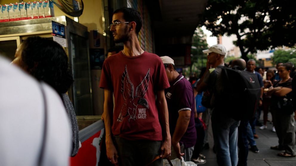 People walk in the streets of Caracas after a massive blackout left the city and other parts of the country without electricity, in Caracas Venezuela, Monday, July 22, 2019. The power in the capital went out around 4:30 p.m. (2030 GMT) and immediatel