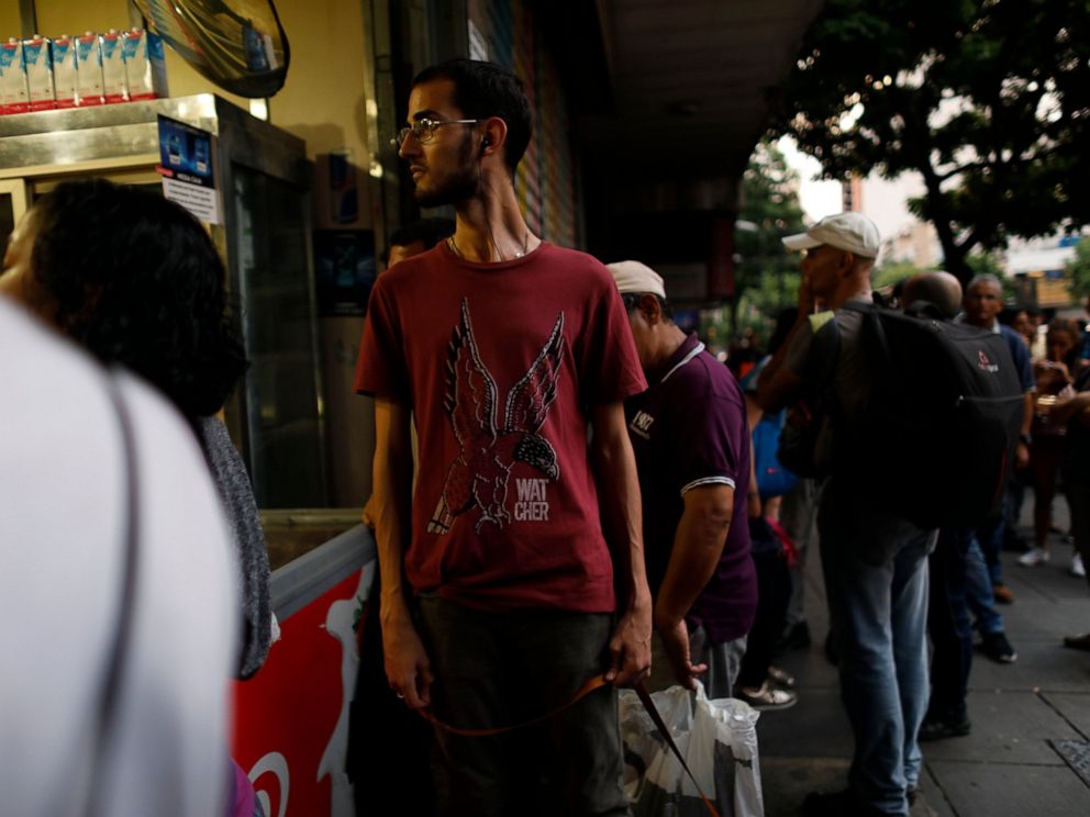 People walk in the streets of Caracas after a massive blackout left the city and other parts of the country without electricity, in Caracas Venezuela, Monday, July 22, 2019. The power in the capital went out around 4:30 p.m. (2030 GMT) and immediatel