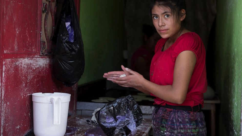 Florinda, 20, from the El Quiche department makes hand-made corn tortillas near La Palmita market in Guatemala City, Saturday, Oct. 16, 2021. Florinda came to the capital four years ago from the western mountainous area and has worked making tortilla