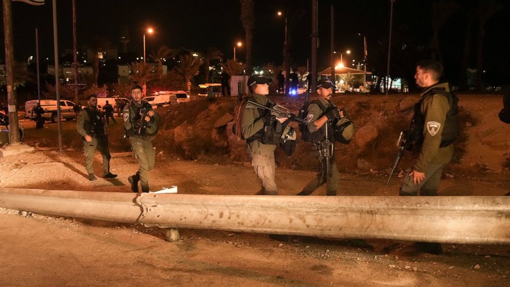 Israeli border police officers patrol next to the scene of a shooting attack outside the Israeli settlement of Maale Adumim, in the West Bank, Wednesday, Oct. 19, 2022. Israeli police say security guards shot dead a Palestinian attacker after he open