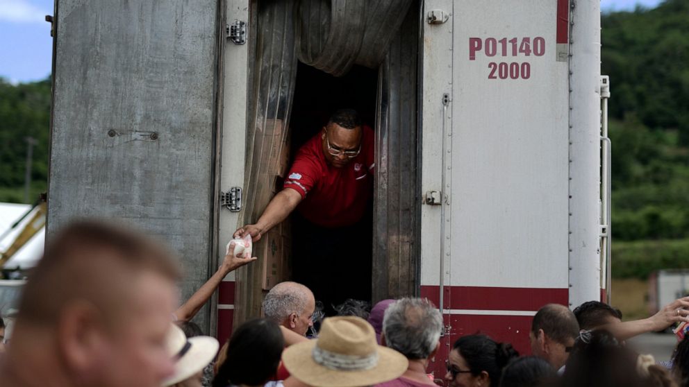 Residents receive aid supplies after suffering the previous day's magnitude 6.4 quake in Yauco, Puerto Rico, Wednesday, Jan. 8, 2020. More than 250,000 The quake that struck before dawn on Tuesday killed one person, injured nine others and knocked ou