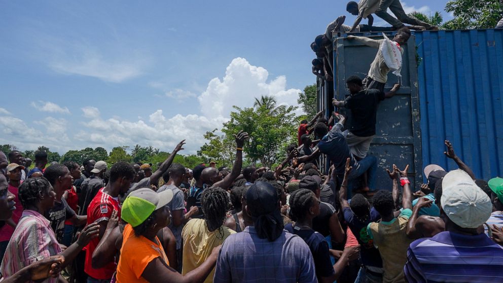 Quake zone Haitians crowd relief shipments, some steal goods