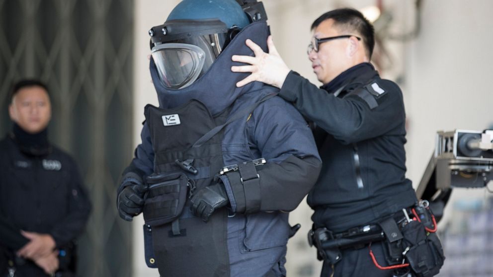 A police officer from the bomb disposal squad putting on protective gear during a demonstration for media in Hong Kong, Friday, Dec. 6, 2019. Hong Kong's much-maligned police force provided a rare behind-the-scenes look Friday at its bomb disposal sq