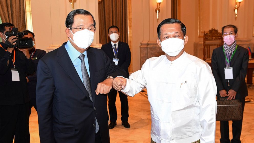 In this photo provided by An Khoun Sam Aun/National Television of Cambodia, Cambodian Prime Minister Hun Sen, left, greets with Myanmar State Administration Council Chairman, Senior General Min Aung Hlaing, right, during a meeting in Naypyitaw, Myanm