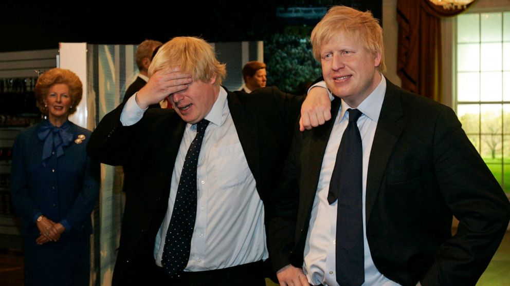 FILE - Mayor of London Boris Johnson, left, poses with a wax figure of himself at Madame Tussauds wax museum in London Tuesday, May 5, 2009, after being introduced to his new wax figure. British media say Prime Minister Boris Johnson has agreed to re