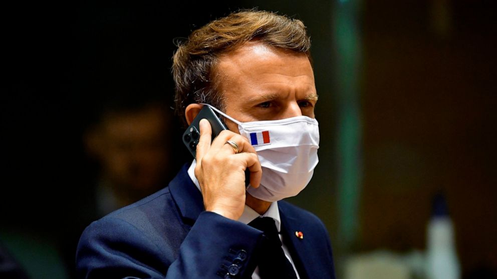 FILE - In this Monday, July 20, 2020 file photo, French President Emmanuel Macron speaks on his mobile phone during a round table meeting at an EU summit in Brussels. French newspaper Le Monde is reporting that the cellphones of French President Emma