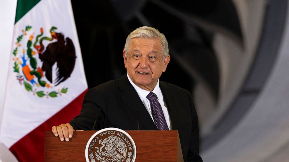 Mexican President Andres Manuel Lopez Obrador gives his daily, morning press conference in front of the former presidential plane at Benito Juarez International Airport in Mexico City, Monday, July 27, 2020. The president, who only flies commercial a