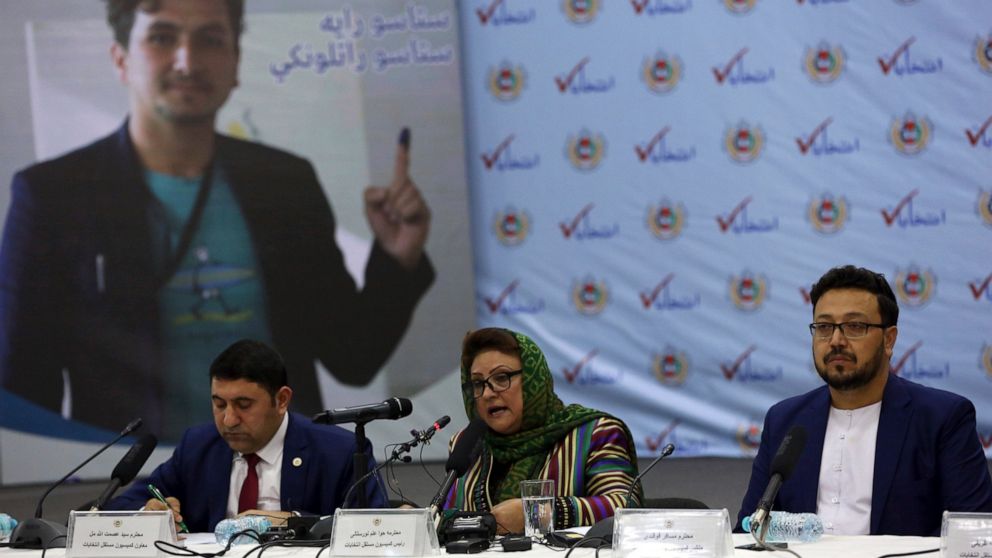 FILE - Hawa Alam Nuristani, chief of Election Commission of Afghanistan, center, speaks during a press conference at the Independent Election Commission office in Kabul, Afghanistan, Feb. 18, 2020. The Taliban dissolved Afghanistan's Independent Elec