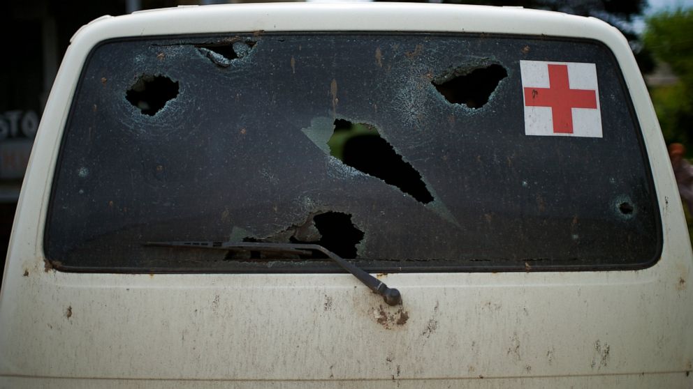 The back window of a vehicle standing outside a medical facility bears holes from shrapnel caused by an explosion earlier during the war, in Donetsk region, eastern Ukraine on Saturday, May 21, 2022. (AP Photo/Francisco Seco)