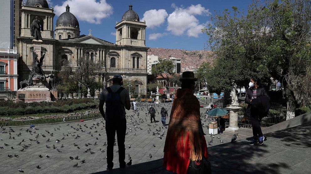 People gather in Plaza Murillo, the main square in downtown La Paz, Bolivia, Monday, Oct. 19, 2020, the morning after general elections. Results trickled in from Bolivia's presidential election, a high-stakes redo of last year's annulled ballot that 
