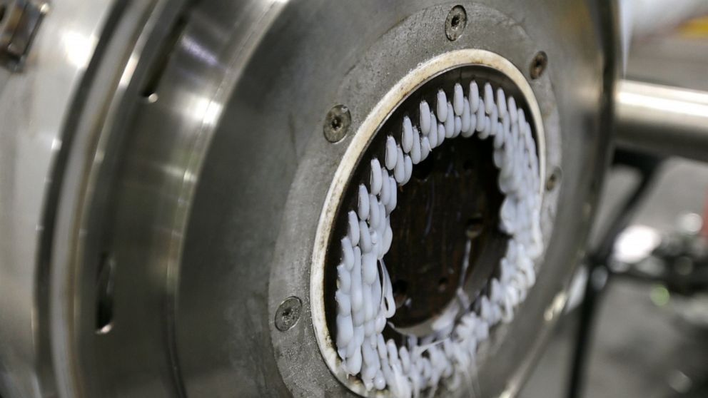 In this May 7, 2019 photo, a machine that produces plastic pellets from plastic film is seen in operation at a GDB International warehouse in New Brunswick, N.J. GDB International exported bales of scrap plastic film such as pallet wrap and grocery b