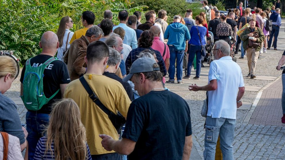 FILE --People queue in front of a polling station in the Moabit district of Berlin, Germany, Sunday, Sept. 26, 2021. A Berlin court on Wednesday ordered a rerun of the German capital's 2021 state election because of severe election-day glitches at ma
