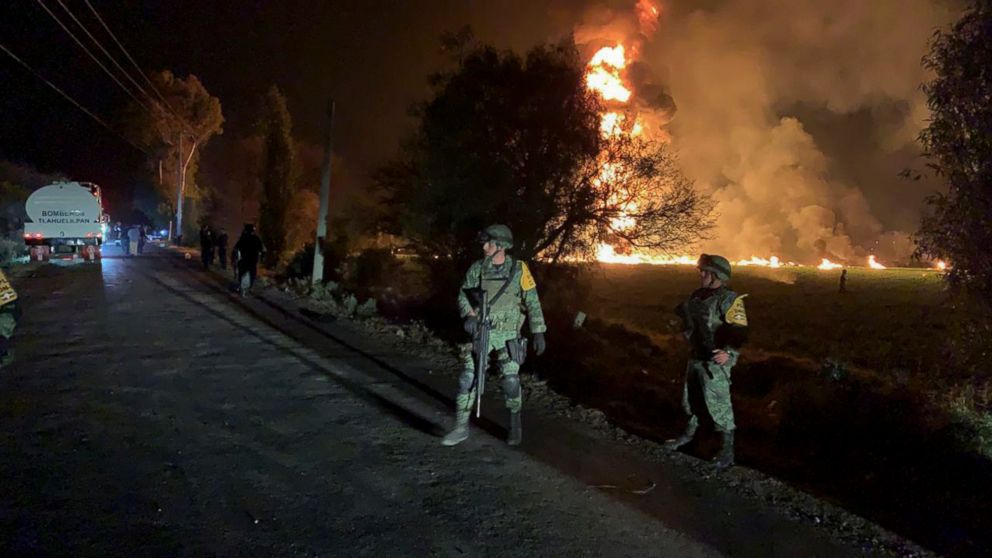 In this image provided by the Secretary of National Defense, soldiers guard in the area near an oil pipeline explosion in Tlahuelilpan, Hidalgo state, Mexico, Friday, Jan. 18, 2019. A huge fire exploded at a pipeline leaking fuel in central Mexico on