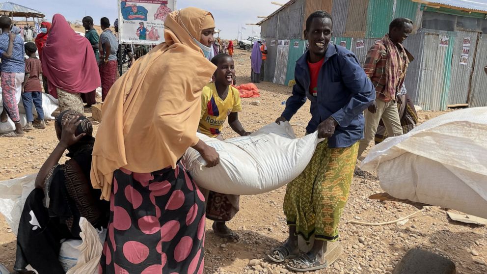 Food supplies are distributed during a visit by World Food Programme (WFP) Regional Director Michael Dunford to a camp for the internally-displaced in Adadle, in the Somali Region of Ethiopia Saturday, Jan. 22, 2022. Drought conditions have left an e