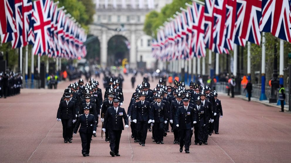 Police officers take positions ahead of the Queen Elizabeth II funeral in central London, Monday, Sept. 19, 2022. The Queen, who died aged 96 on Sept. 8, will be buried at Windsor alongside her late husband, Prince Philip, who died last year. (AP Pho