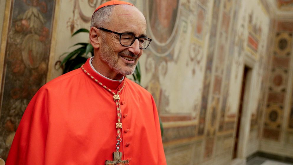 FILE - Cardinal Michael Czerny poses for photographers prior to meeting relatives and friends after he was elevated to cardinal by Pope Francis, at the Vatican, Oct. 5, 2019. Cardinal Michael Czerny marked the 80th anniversary of the gas chamber kill