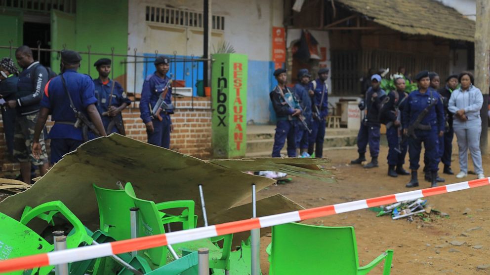 An area is cordoned off as police officers inspect the scene of a bomb explosion in Beni, eastern Congo Sunday Dec. 26, 2021. A bomb exploded at a restaurant Saturday as patrons gathered on Christmas Day in an eastern Congolese town where Islamic ext