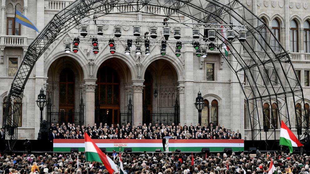 Hungary's right-wing populist prime minister, Viktor Orban addresses thousands of supporters as they gather in Budapest, Hungary, Tuesday, March 15, 2022. The so-called "peace march" was a show of strength by Orban's supporters ahead of national elec