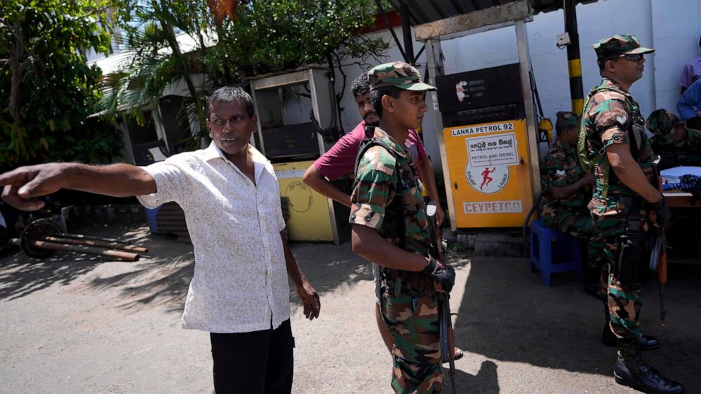 People complain about unavailability of fuel to army soldiers who secure a fuel station in Colombo, Sri Lanka, Monday, June 27, 2022. Sri Lanka is sending two ministers to Russia to negotiate for fuel — one of the necessities that the Indian ocean is