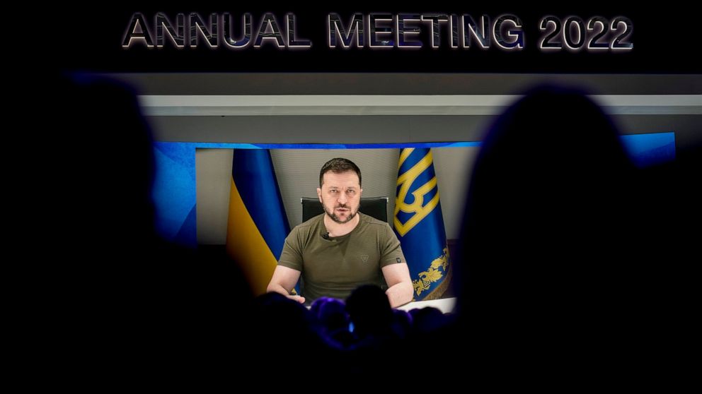 Ukrainian President Volodymyr Zelenskyy displayed on a screen as he addresses the audience from Kyiv on a screen during the World Economic Forum in Davos, Switzerland, Monday, May 23, 2022. The annual meeting of the World Economic Forum is taking pla