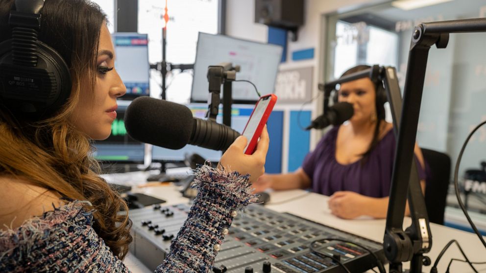 Melanie Nagy, left, and Szandi Minzari, hosts of Radio Dikh's women's show 'Zsa Shej', work together in a radio studio in Budapest, Hungary, Friday May 6, 2022. Intellectuals, broadcasters and cultural figures from Hungary’s Roma community have found