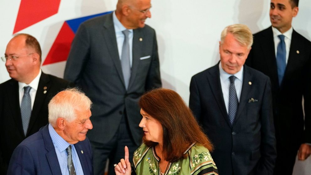 Sweden's Foreign Minister Ann Linde, center, speaks with European Union foreign policy chief Josep Borrell, second left, during a group photo of EU foreign ministers at the Prague Congress Center in Prague, Czech Republic, Wednesday, Aug. 31, 2022. O
