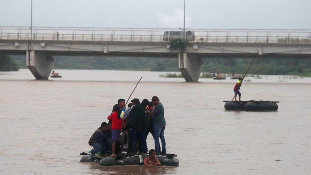 Central American migrants aboard a raft get across he Suchiate river on the Guatemala – Mexico border, near Ciudad Hidalgo, Mexico, early Friday, May 31, 2019. Migrants are increasingly coming into the US in large groups. The Border Patrol said it ha