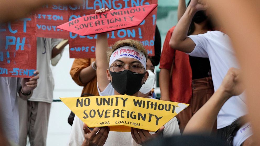 Protesters hold slogans to mark the 6th anniversary of the issuance of the 2016 decision by an arbitration tribunal set up under the U.N. Convention of the Law of the Sea after the Philippines complained against China's increasingly aggressive action