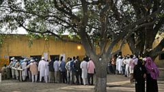 FILE - In this Thursday, April 11, 2019 file photo, Indians stand in a queue to cast their votes outside a polling station in Sawaal village, near Meerut, India. The final phase of India’s marathon general election will be held on Sunday, May 19. The