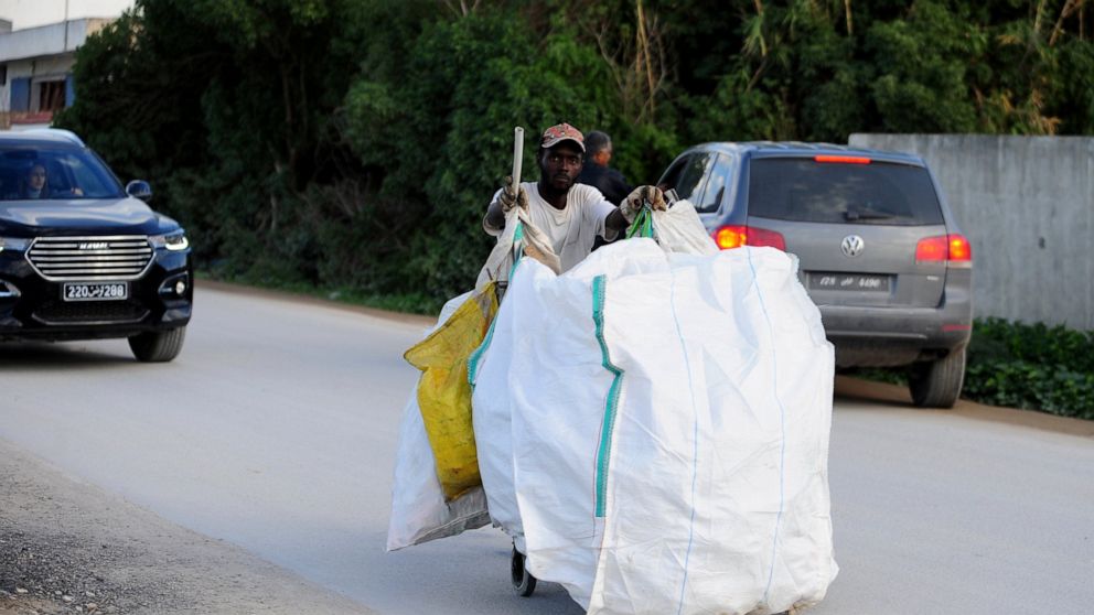 A plastic picker works in La Marsa, outside Tunis, Wednesday, Dec. 14, 2022. To outsiders, Tunisia’s legislative elections Saturday, Dec. 17, 2022 look questionable: Many opposition parties are boycotting. A new electoral law makes it harder for wome