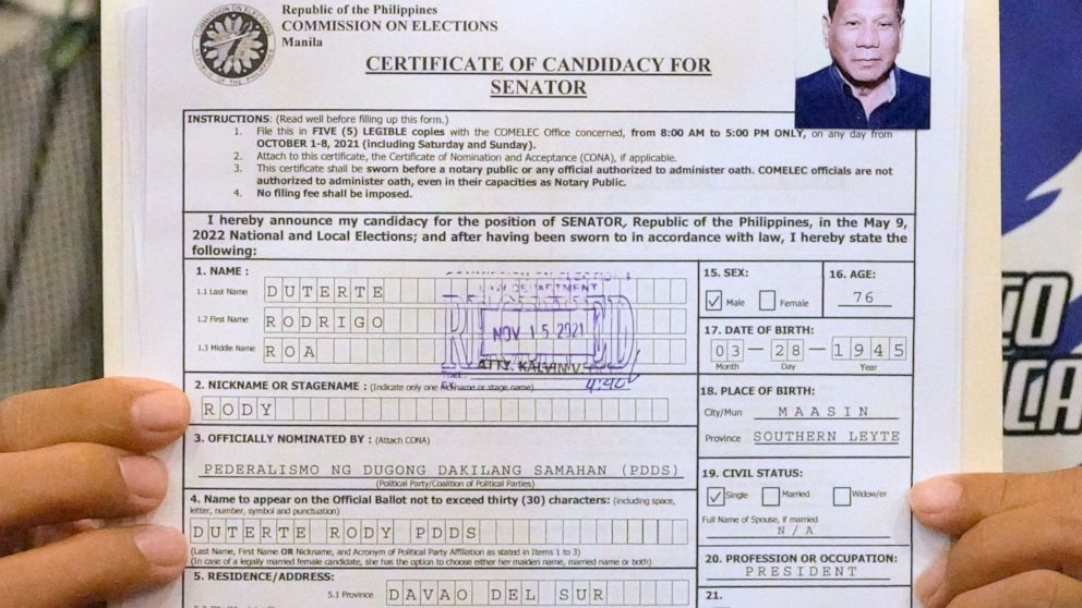 A representative of Philippine President Rodrigo Duterte holds his Certificate of Candidacy for Senator at the Commission on Elections in Manila, Philippines,Monday, Nov. 15, 2021. Duterte filed his candidacy Monday for a Senate seat in next year's e