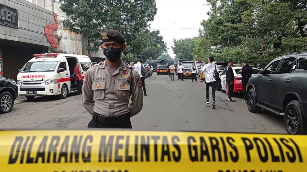A police officer stands guard on a road leading to the police station where an explosion went off in Bandung, West Java, Indonesia, Wednesday, Dec. 7, 2022. An unidentified attacker blew himself up outside a police station in Indonesia’s main island 