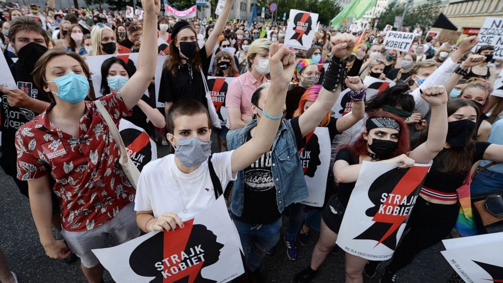 Protesters with a banner reading "Women's Strike" taking part in a rally against Polish government plans to withdraw from the Istanbul Convention on prevention and combatting of home violence,in Warsaw, Poland, Friday, July 24, 2020. In the opinion o
