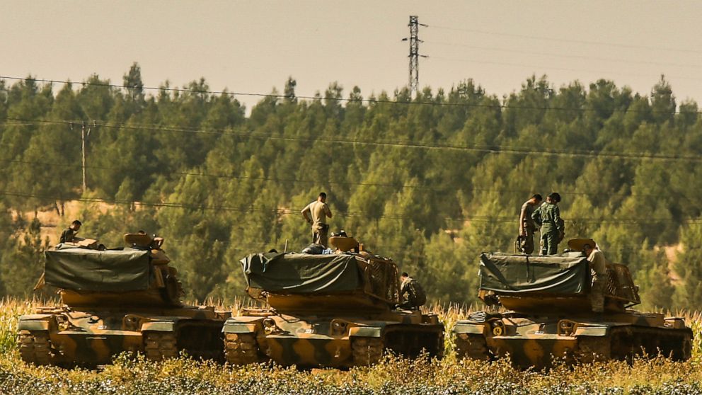 Turkish soldiers stand atop of their tanks at a staging area close to the border with Syria in Sanliurfa province, southeastern Turkey, Thursday, Oct. 17, 2019. U.S. Vice President Mike Pence and State Secretary Mike Pompeo were scheduled to arrive i