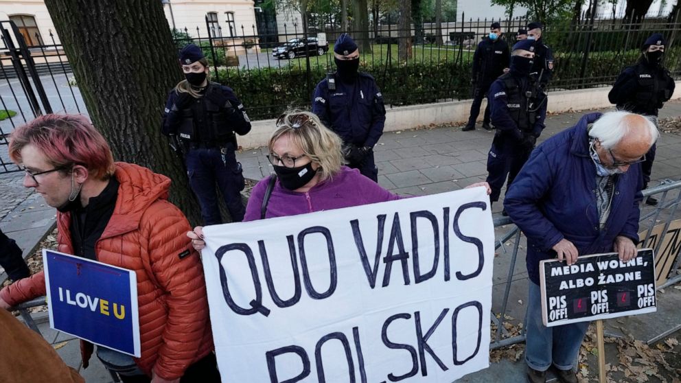 People stage a protest in front of Poland's constitutional court, in Warsaw, Poland, Thursday, October 7, 2021. Poland’s constitutional court has ruled that some European Union laws are in conflict with Poland’s Constitution. The Constitutional Tribu