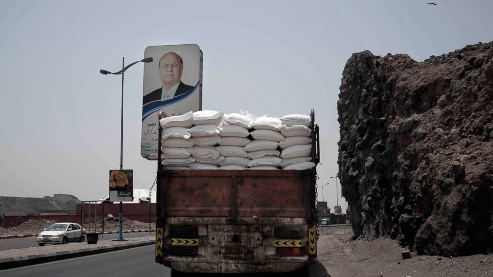 A truck carries aid on a road in Aden, Yemen, in this July 23, 2018, photo. Relief workers in Yemen said armed factions often manipulate lists of those registered to receive food aid to divert it to their own supporters and families. “Who gets on the