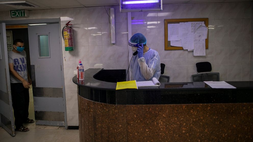 Palestinian doctors wear protective clothes as they work at the emergency room of the al-Quds Hospital in Gaza City, Monday, Sept. 7, 2020. Dozens of front-line health care workers have been infected, dealing a new blow to overburdened hospitals. (AP